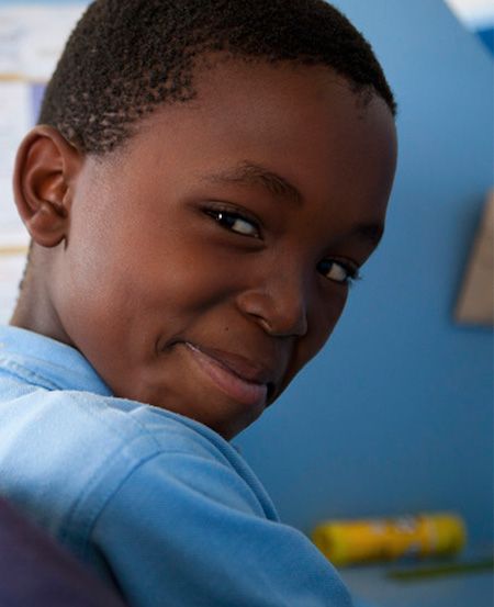 Young boy looking over his shoulder smiling